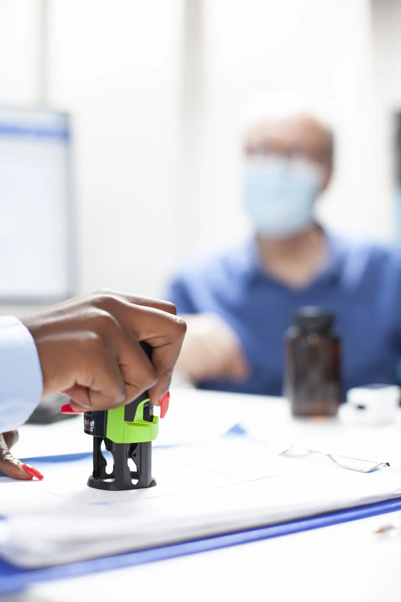 Black person stamping on medical records