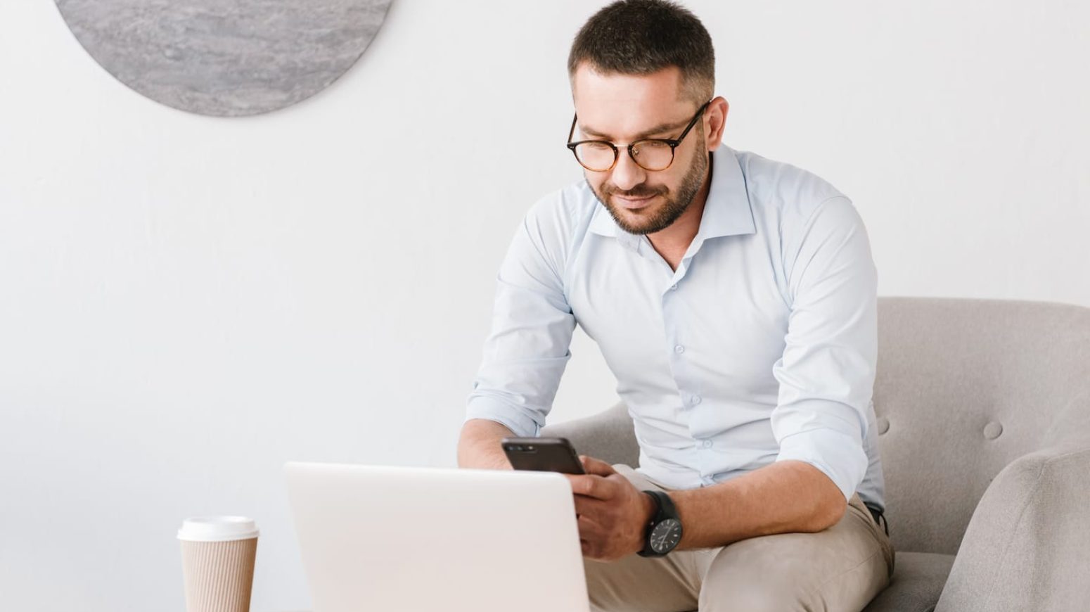 photo-of-business-man-wearing-eyeglasses-sitting-PB3SK4U