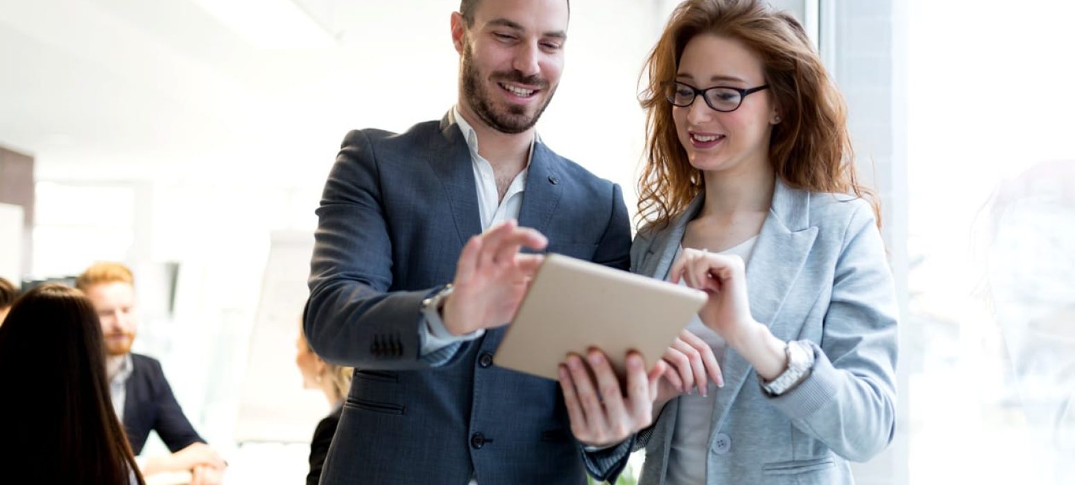 smiling-happy-colleagues-working-at-company-UMG8QDX